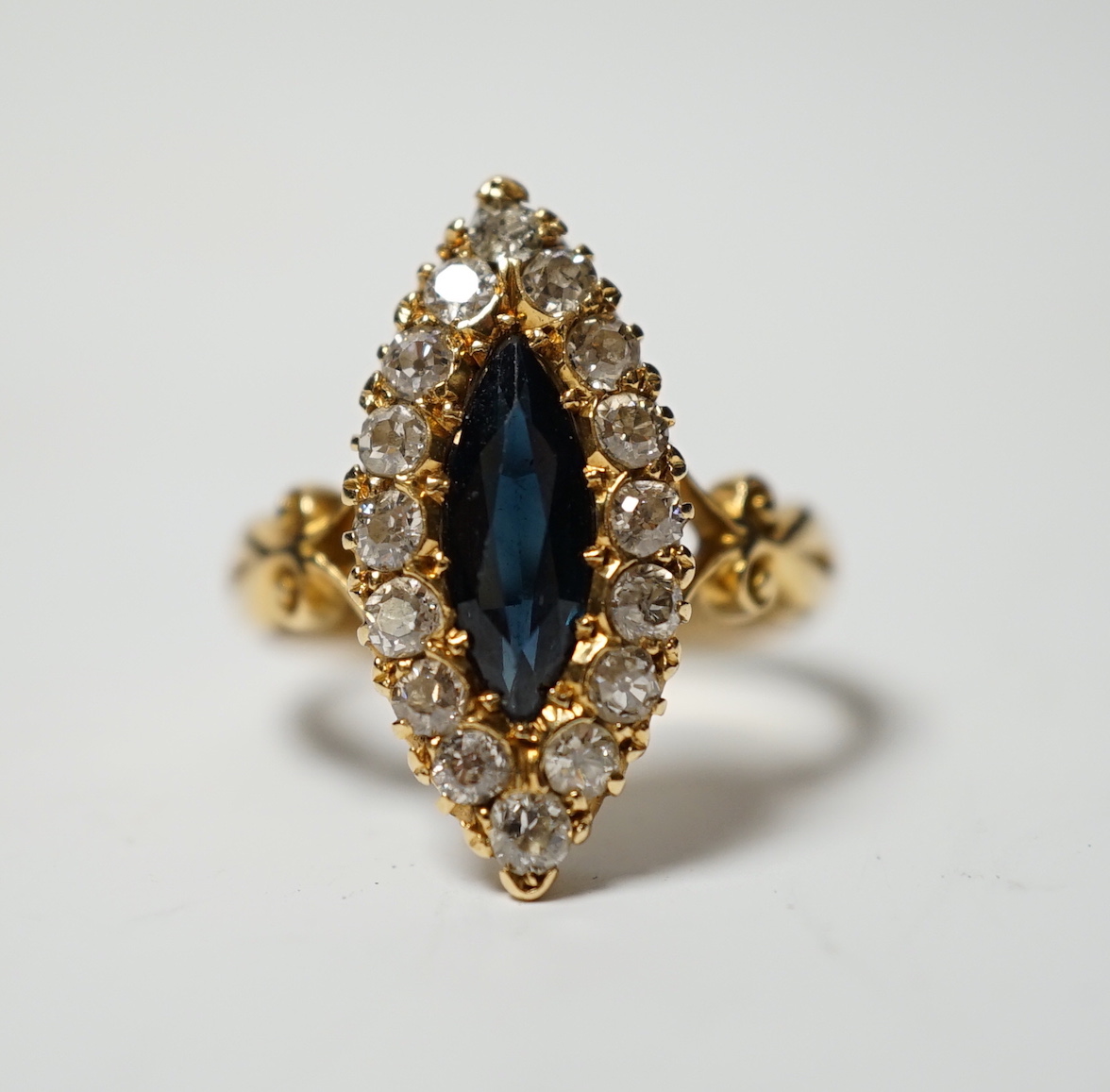 An Edwardian 18ct gold, sapphire and diamond cluster set marquise shaped ring, size K, gross weight 4.2 grams.